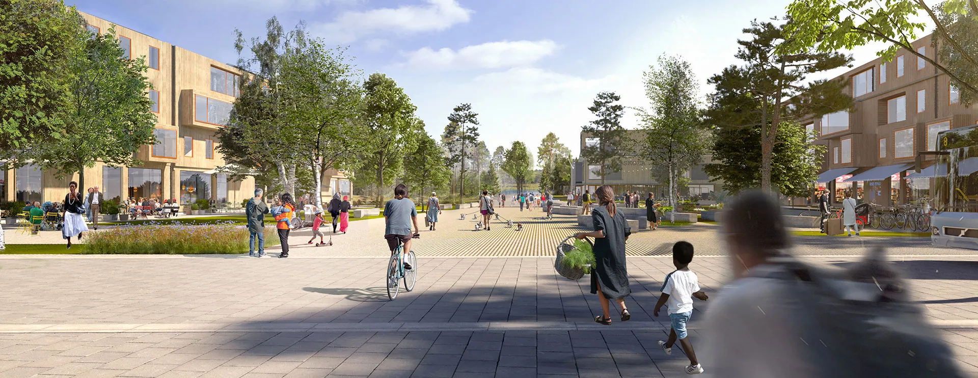 Personer rör sig på torget och Nydalasjön skymtar.